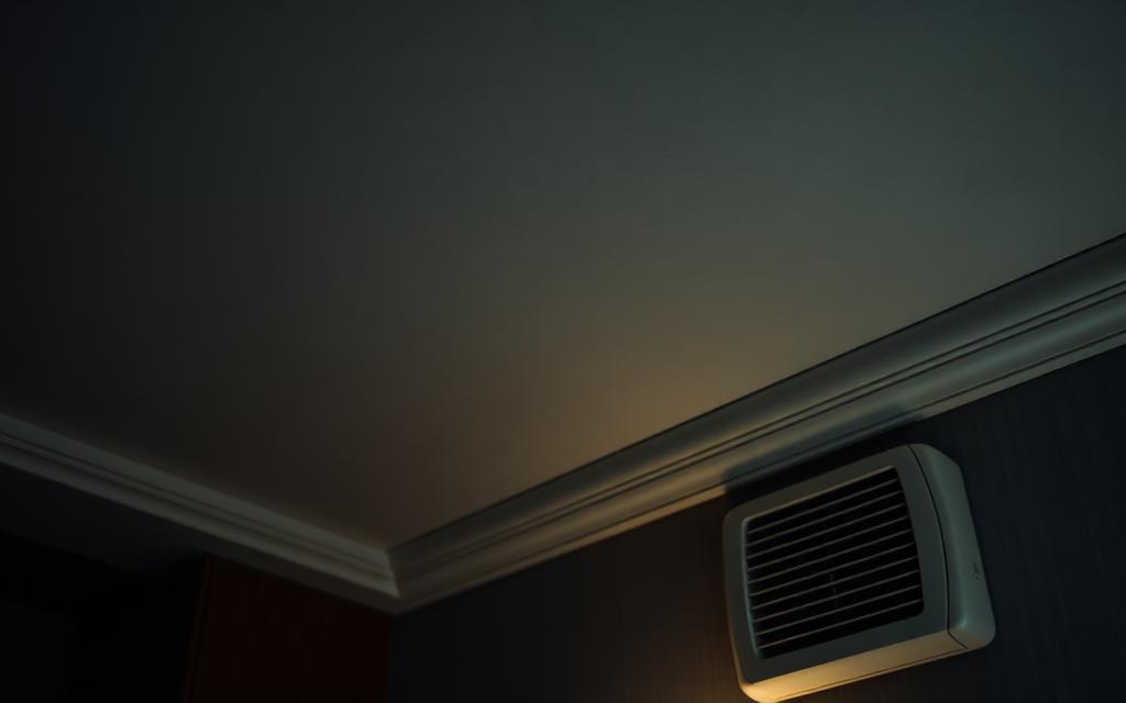Guest room ceiling and wall-mounted air-conditioning unit showing moisture discoloration during a hotel field investigation